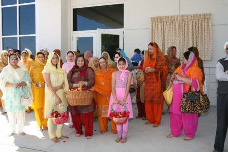 Sangat waiting with flower petals for the arrival of Sri Guru Granth Sahib Ji's 'sawari'